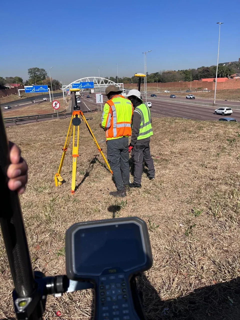 Surveyors working together with field equipment on a project site